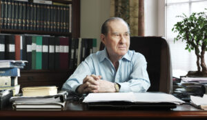Founder Laszlo Szombatfalvy sitting in his office looking to the side.